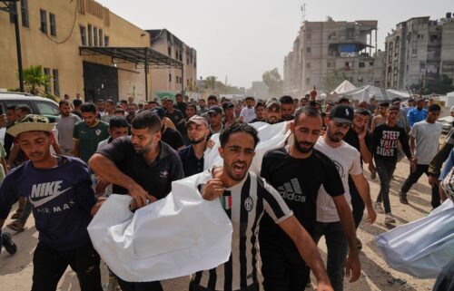Palestinians carry the bodies of their relatives killed in an Israeli airstrike