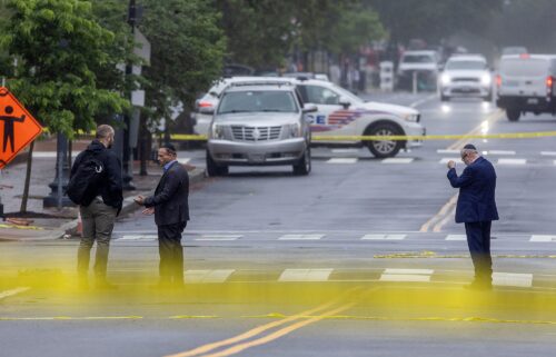 Police and Investigators work at the crime scene on May 22.